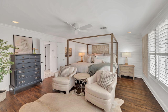 bedroom with visible vents, ornamental molding, dark wood-type flooring, baseboards, and ceiling fan