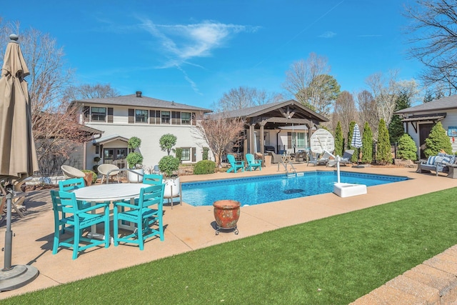 outdoor pool with a patio area