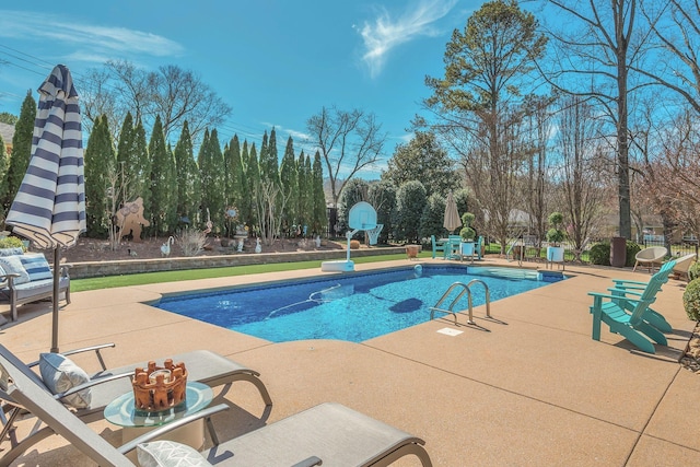 outdoor pool with a patio area