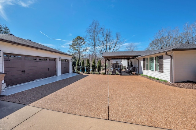 view of side of home with fence and a garage