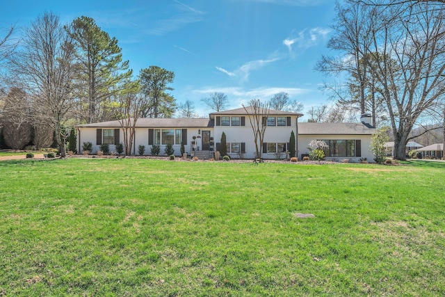 rear view of property with a lawn and stucco siding