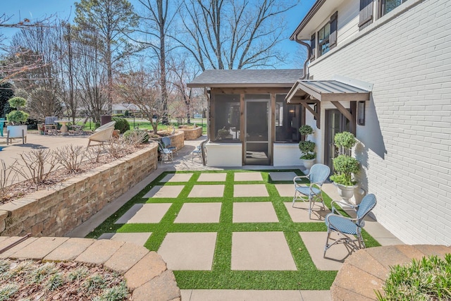view of patio / terrace featuring a sunroom