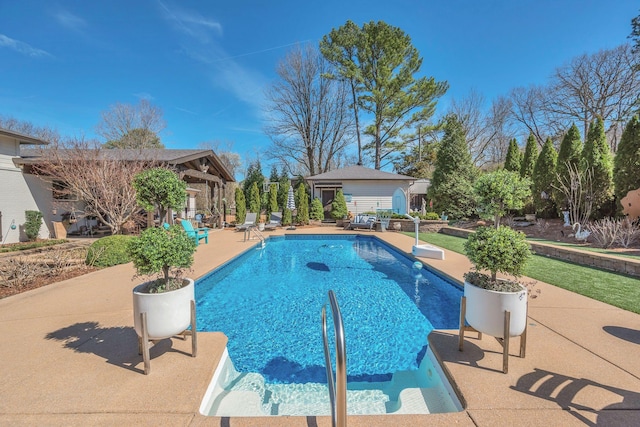 pool with an outbuilding and a patio
