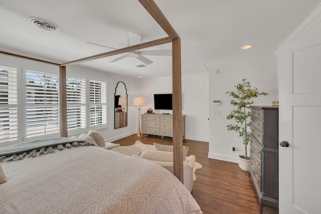 bedroom with ornamental molding, wood finished floors, and visible vents