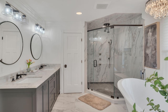 full bath with marble finish floor, a freestanding tub, a sink, and a marble finish shower