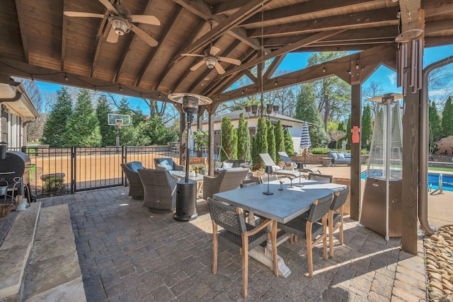 view of patio / terrace featuring a ceiling fan, a fenced in pool, outdoor dining area, and fence