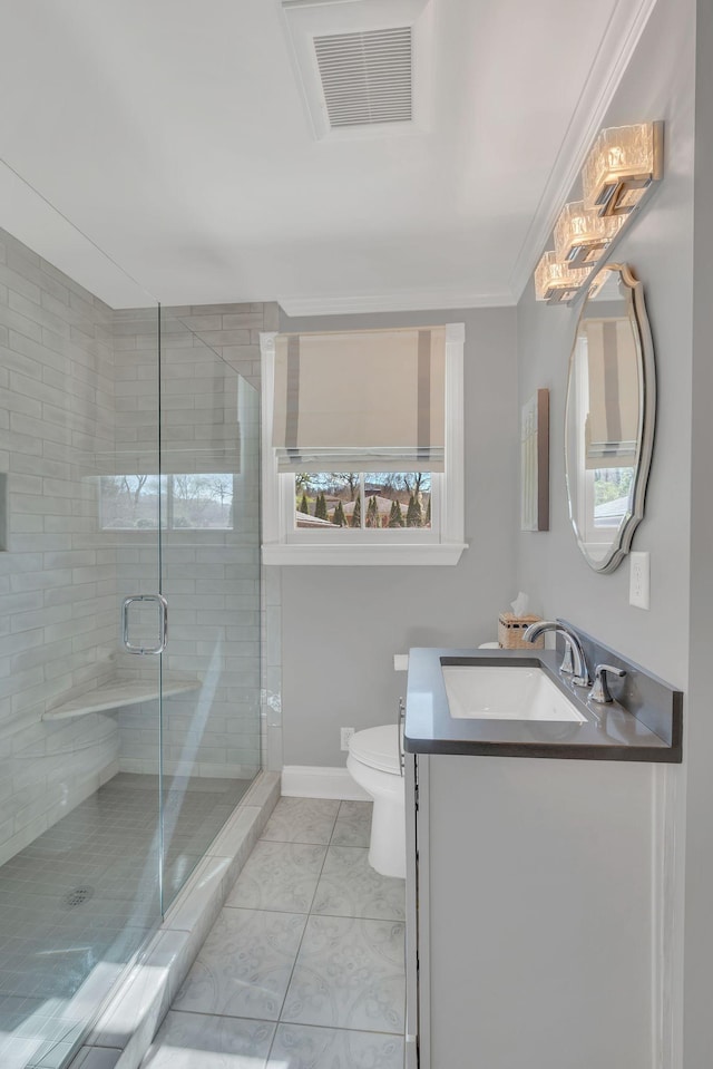 bathroom with toilet, visible vents, a shower stall, and a healthy amount of sunlight
