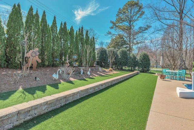 surrounding community featuring a lawn, fence, and a patio area