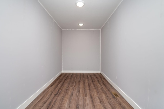 interior space featuring baseboards and wood finished floors