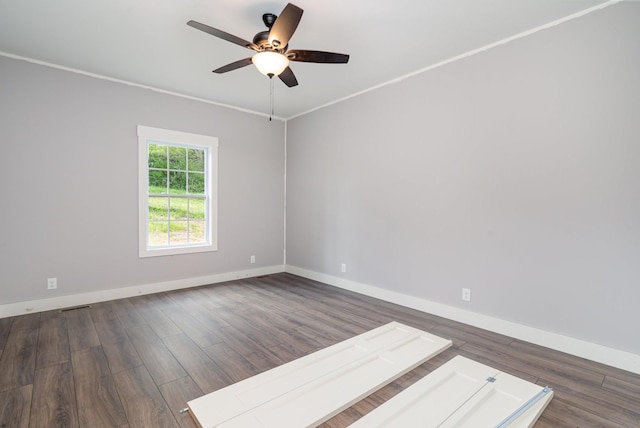 spare room with baseboards, a ceiling fan, wood finished floors, and visible vents