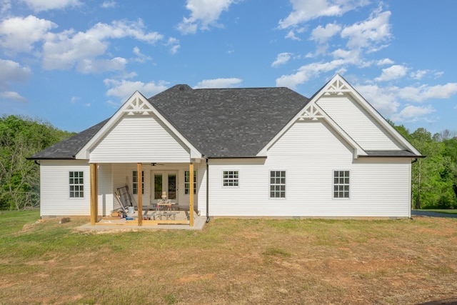 back of house featuring a lawn, a shingled roof, ceiling fan, and a patio