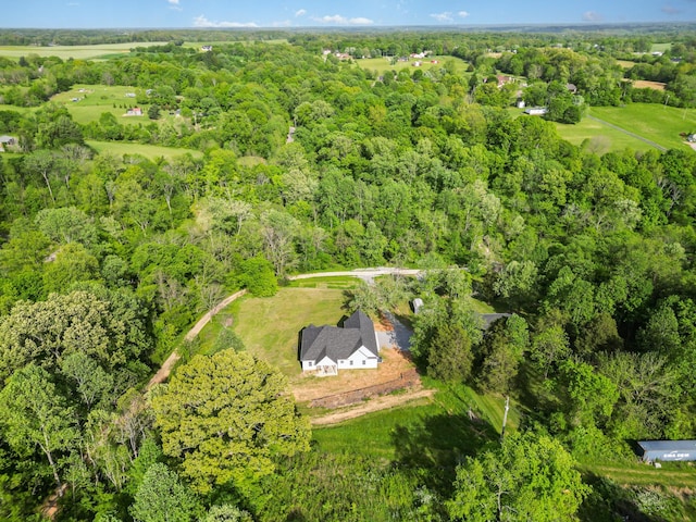 bird's eye view with a wooded view