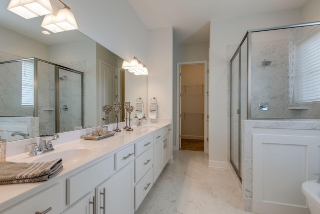 bathroom featuring a shower stall, marble finish floor, and a sink