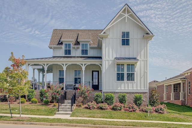 modern farmhouse style home with board and batten siding, a standing seam roof, and covered porch