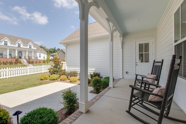view of patio with fence and a residential view