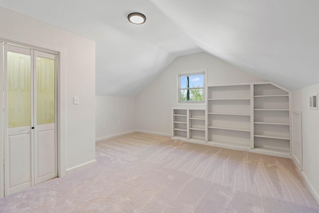 additional living space featuring lofted ceiling, visible vents, carpet flooring, and baseboards
