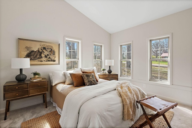 bedroom with high vaulted ceiling and carpet floors