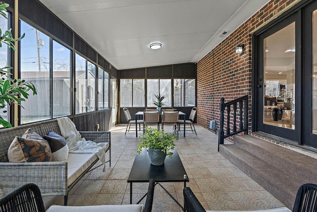 sunroom / solarium featuring outdoor dining area, outdoor lounge area, and visible vents