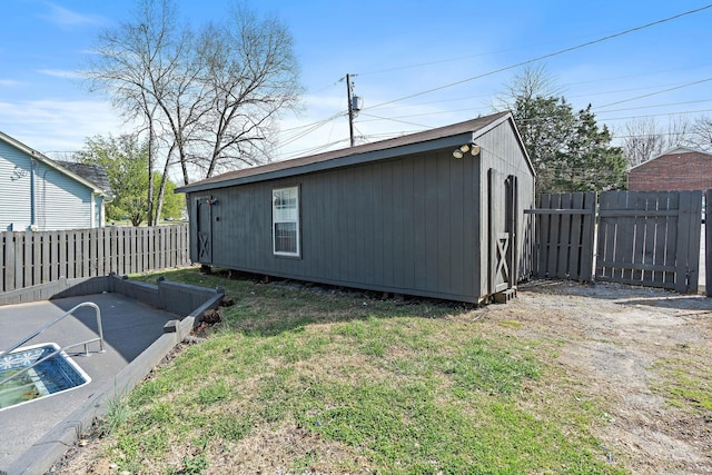 view of side of home featuring a lawn and a fenced backyard