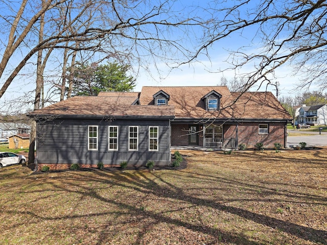 view of front of house with covered porch and a front yard