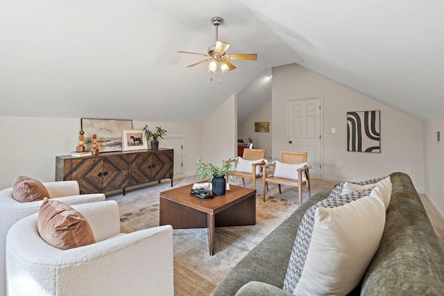 living room featuring lofted ceiling, a ceiling fan, and baseboards