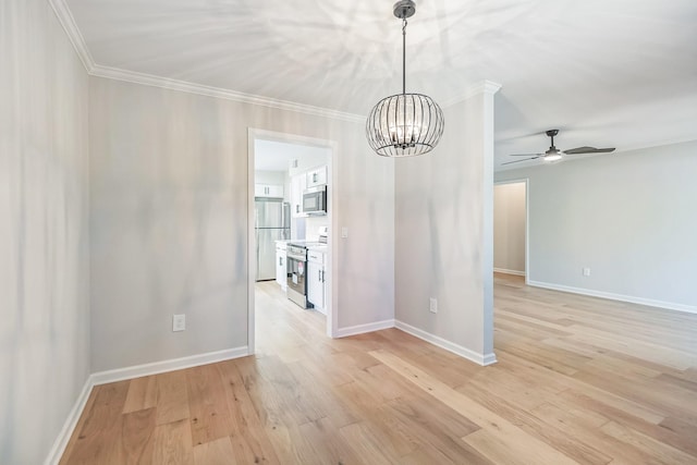 unfurnished dining area featuring light wood-style flooring, baseboards, ornamental molding, and ceiling fan with notable chandelier