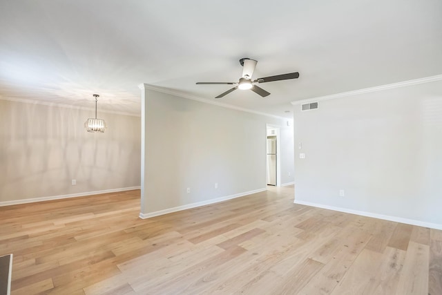 unfurnished room with visible vents, light wood finished floors, ornamental molding, and ceiling fan with notable chandelier