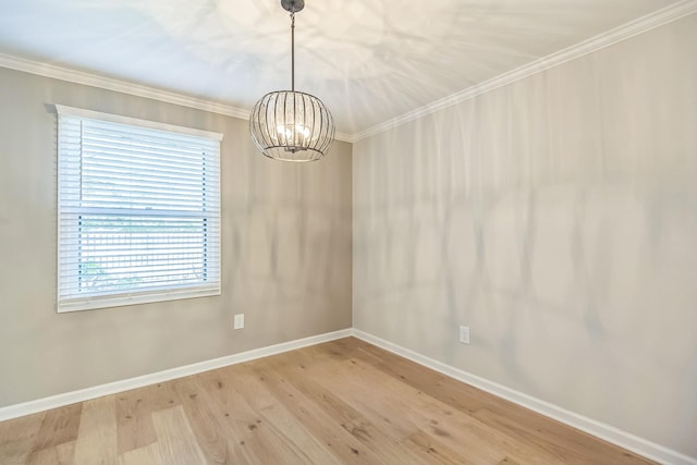 unfurnished dining area featuring wood finished floors, baseboards, a notable chandelier, and crown molding