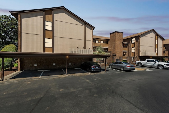 view of property with covered and uncovered parking