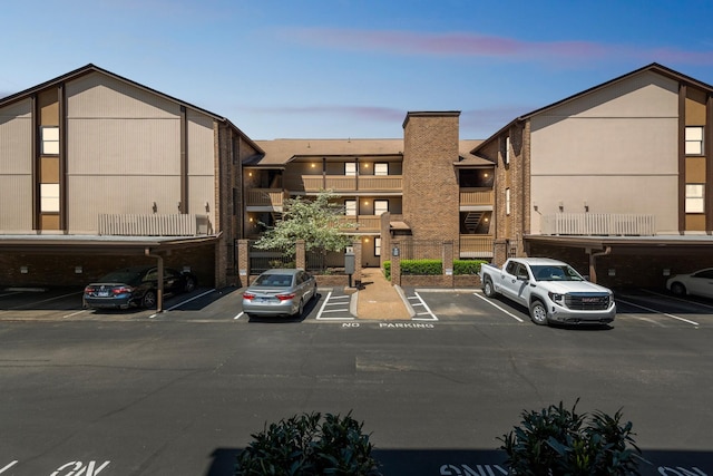 view of building exterior featuring uncovered parking