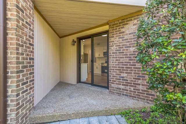 entrance to property with brick siding