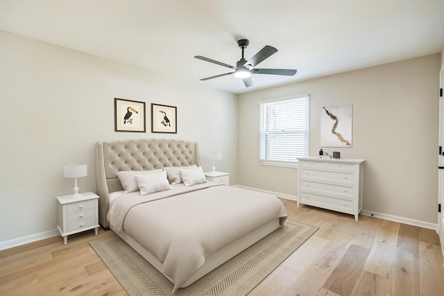 bedroom featuring light wood-type flooring, baseboards, and ceiling fan