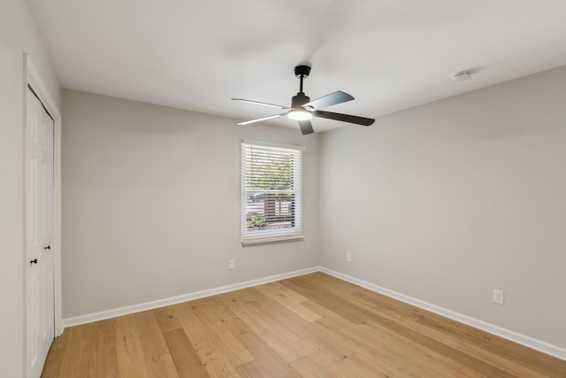 unfurnished bedroom with baseboards, a closet, and light wood-style flooring