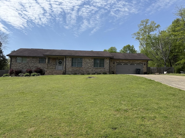 single story home with fence, an attached garage, a front yard, and concrete driveway