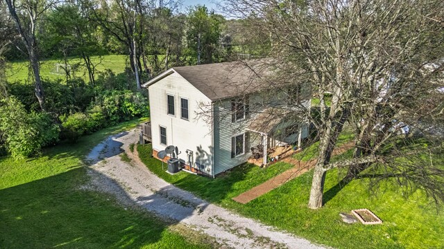 524 Woods Dr, Columbia, TN 38401 - exterior space with a yard, dirt driveway, and roof with shingles