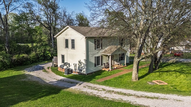 524 Woods Dr, Columbia, TN 38401 - view of property exterior featuring central air condition unit, driveway, and a lawn