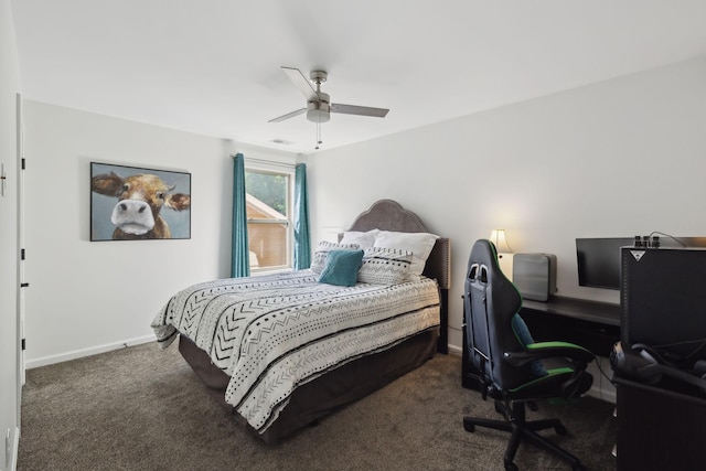 carpeted bedroom with an office area, baseboards, and a ceiling fan