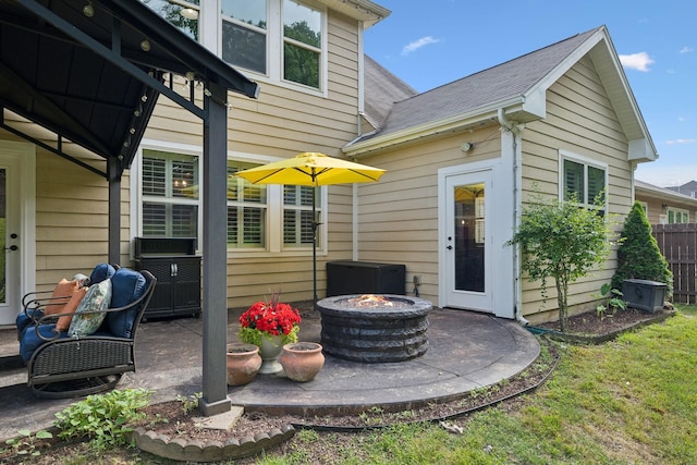 view of patio / terrace featuring an outdoor fire pit and central AC unit