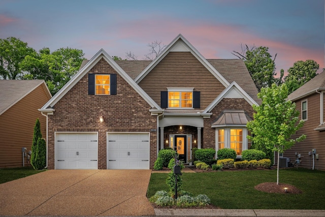 view of front of property featuring brick siding, driveway, a yard, and cooling unit