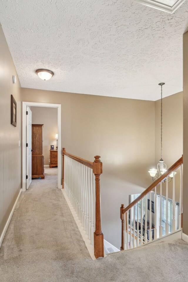 313 Walpole Ct, Nolensville, TN 37135 - hall featuring an inviting chandelier, carpet flooring, an upstairs landing, and baseboards