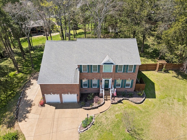 313 Walpole Ct, Nolensville, TN 37135 - colonial-style house with a front lawn, driveway, fence, brick siding, and an attached garage