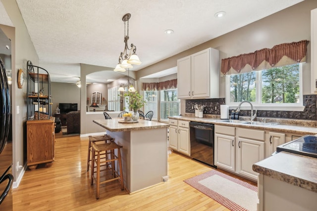313 Walpole Ct, Nolensville, TN 37135 - kitchen featuring decorative backsplash, light wood-style floors, black dishwasher, and a sink