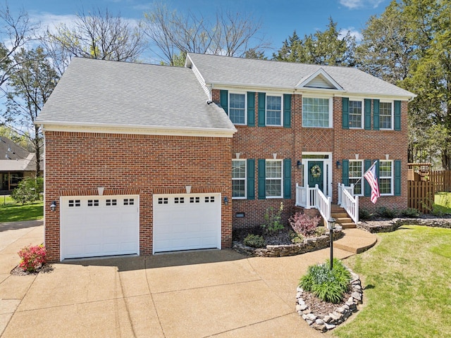 313 Walpole Ct, Nolensville, TN 37135 - colonial home featuring a garage, a front lawn, brick siding, and concrete driveway