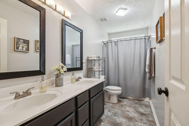 313 Walpole Ct, Nolensville, TN 37135 - bathroom featuring double vanity, a textured ceiling, toilet, and a sink