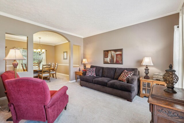 313 Walpole Ct, Nolensville, TN 37135 - living area with ornamental molding, arched walkways, carpet floors, a chandelier, and a textured ceiling