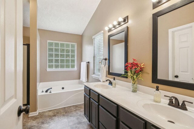 313 Walpole Ct, Nolensville, TN 37135 - full bathroom featuring a garden tub, vaulted ceiling, a sink, and double vanity