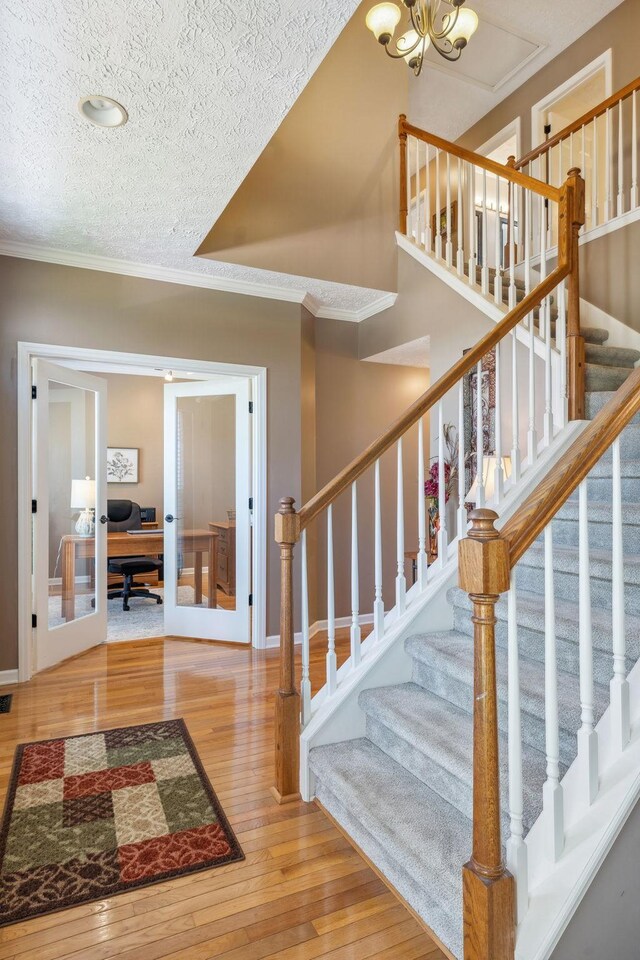 313 Walpole Ct, Nolensville, TN 37135 - stairs featuring ornamental molding, french doors, wood-type flooring, baseboards, and a textured ceiling