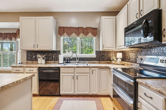 313 Walpole Ct, Nolensville, TN 37135 - kitchen featuring a wealth of natural light, light wood-style flooring, a sink, and black appliances