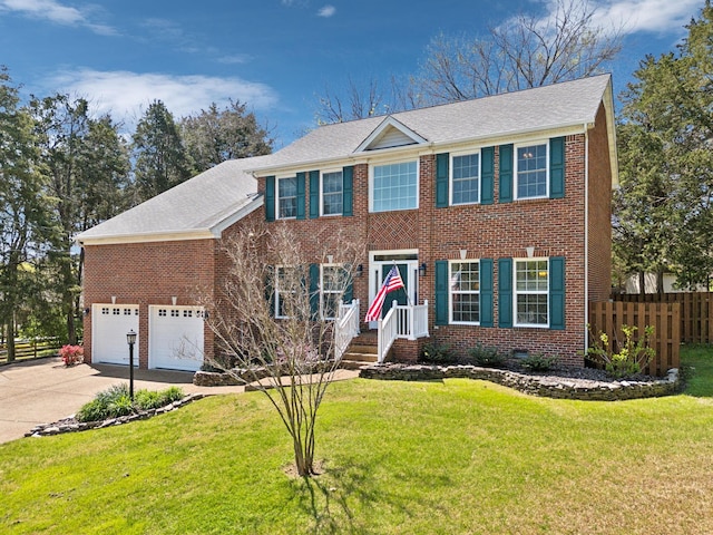 313 Walpole Ct, Nolensville, TN 37135 - colonial inspired home with brick siding, a front yard, concrete driveway, and fence