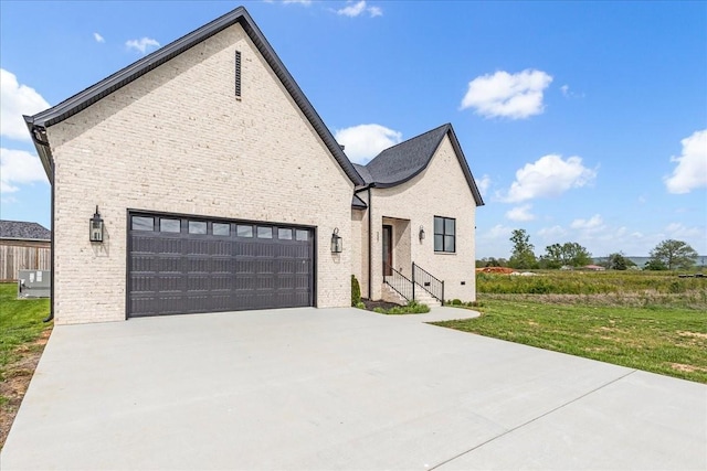 view of front facade with a front lawn, cooling unit, concrete driveway, brick siding, and a garage